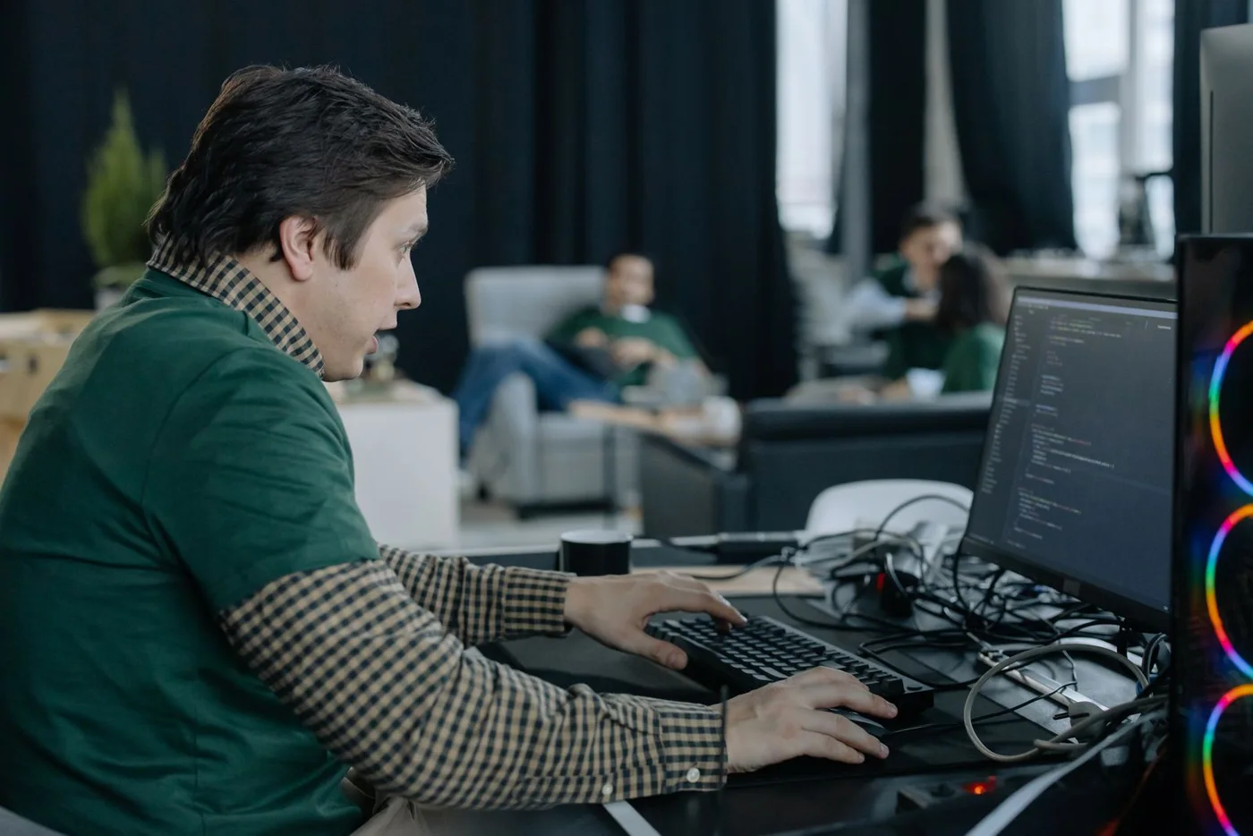 A programmer working at a desktop computer.