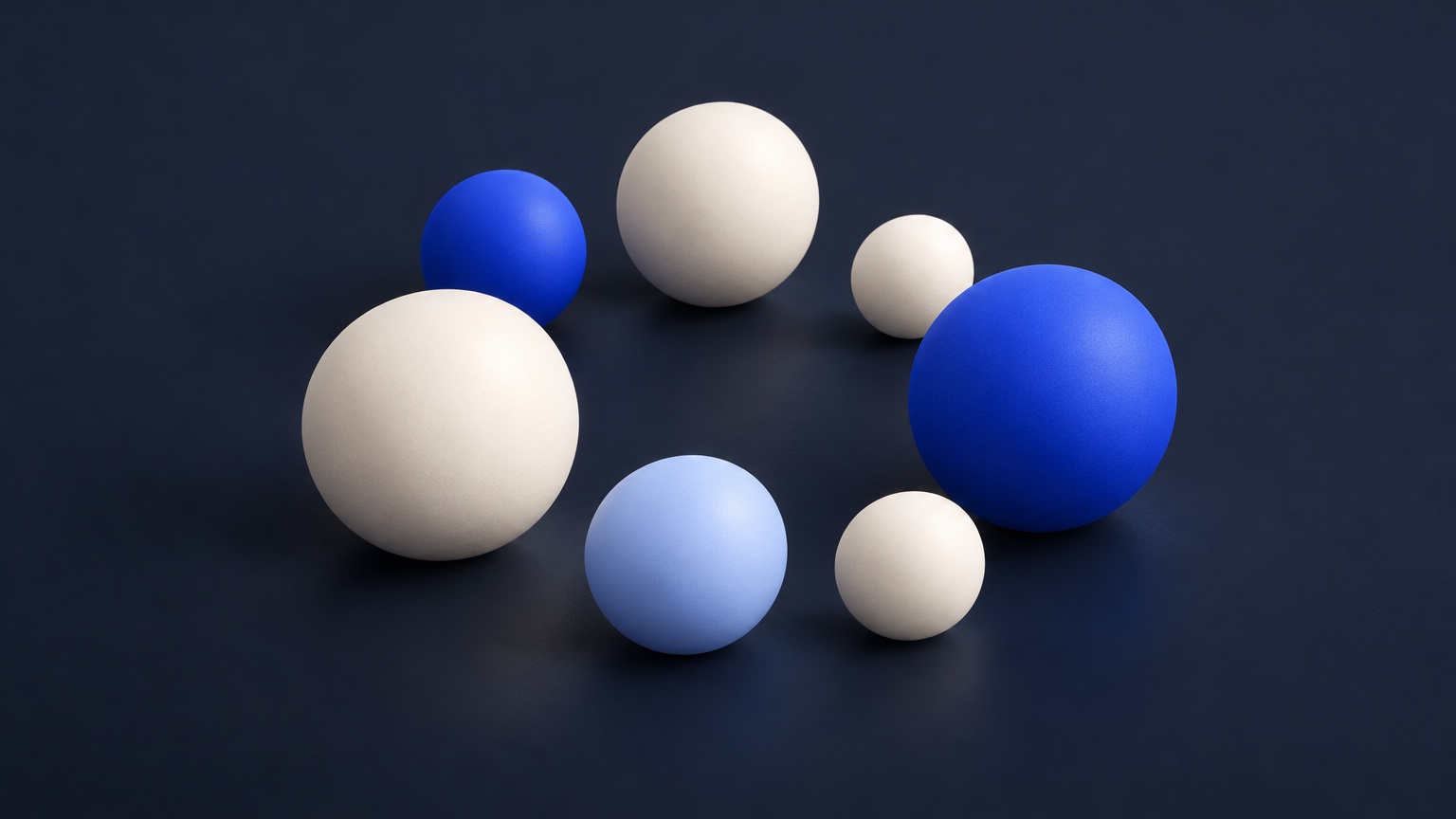 Seven ivory, cobalt and pale blue spheres gathered in a loose ring.